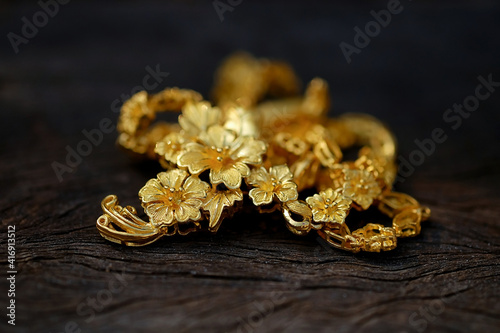 jewelry gold on wood background .