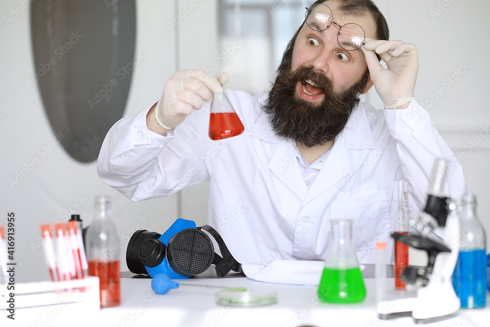 Chemist crazy. A mad scientist conducts experiments in a scientific laboratory. Performs research using a microscope. Chemist crazy. A mad scientist conducts experiments in a scientific laboratory. Performs research using a microscope.