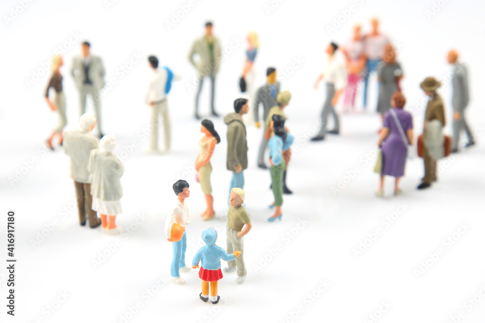 miniature people. different people communicate with each other on a white background miniature people. different people communicate with each other on a white background