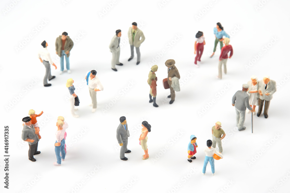 miniature people. different people communicate with each other on a white background