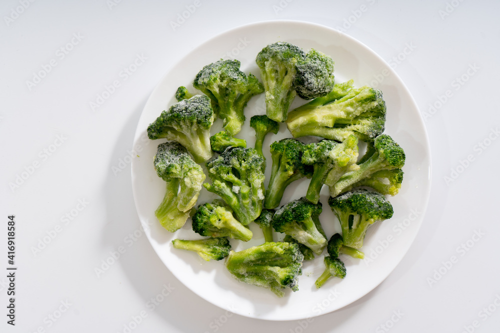 Frozen vegetables. Broccoli. White background Frozen vegetables. Broccoli. White background