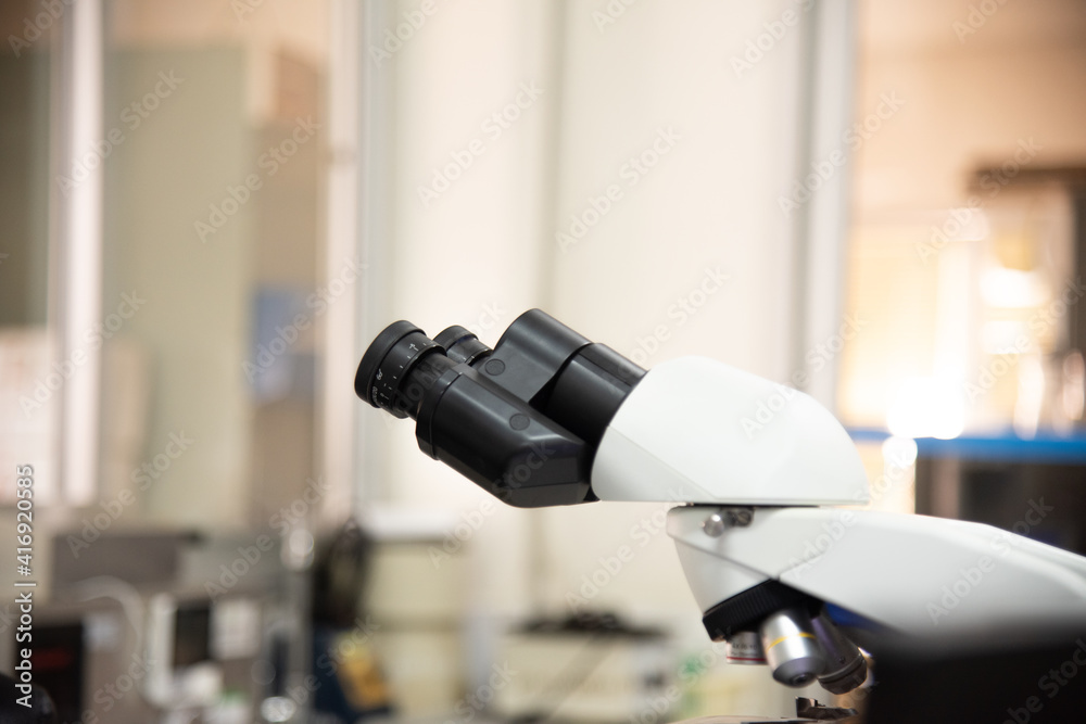 MIcroscope in laboratory with blur  background.