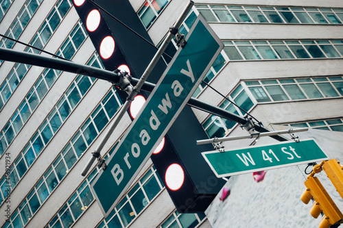 Street sign of Broadway and West 41st with skylines in background.- New York, USA photo