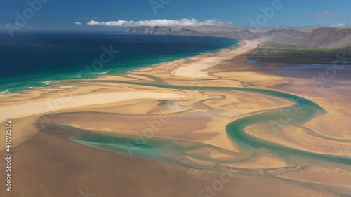 Scenery yellow sand and turquoise rivers at Raudasandur beach. Drone aerial footage at West Fjords in Iceland photo