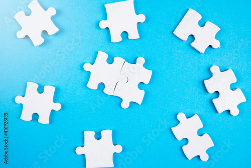 Puzzle pieces on blue background.