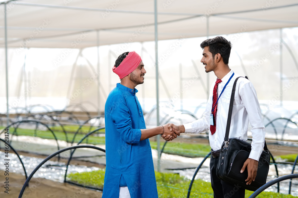 Young indian agronomist with farmer at greenhouse Young indian agronomist with farmer at greenhouse