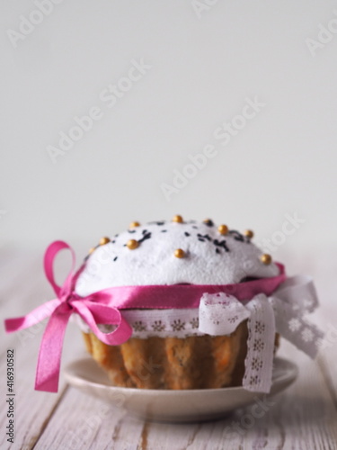 Festive homemade cakes for Easter Sunday, decorated with ribbons, on a light background.