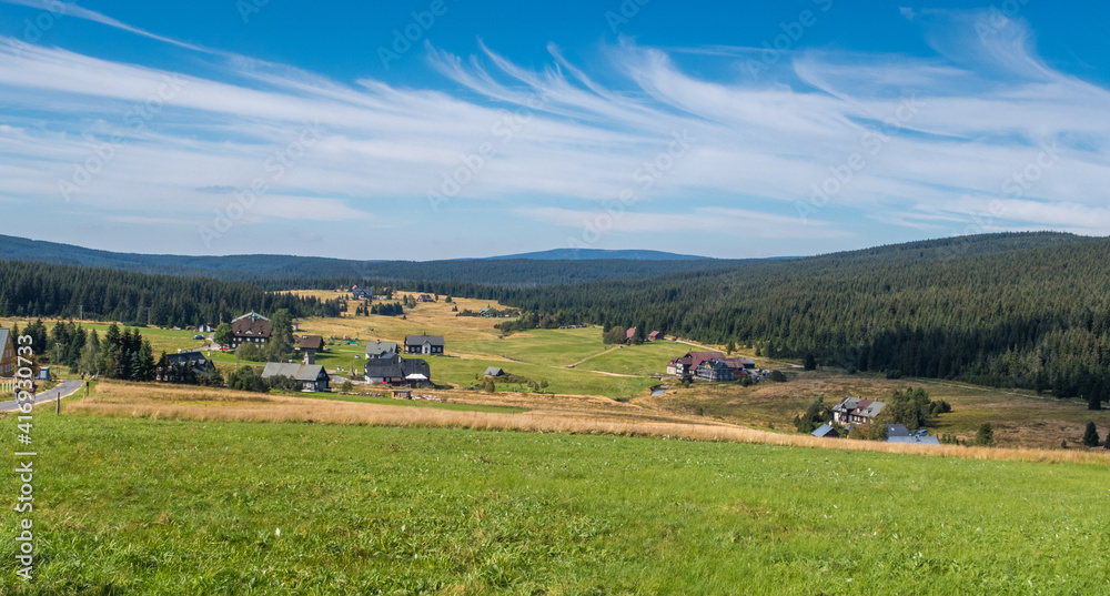 mountain settlement - landscape with mountains and blue sky with clouds / czech republic - jizerka