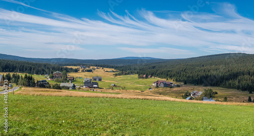 mountain settlement - landscape with mountains and blue sky with clouds / czech republic - jizerka