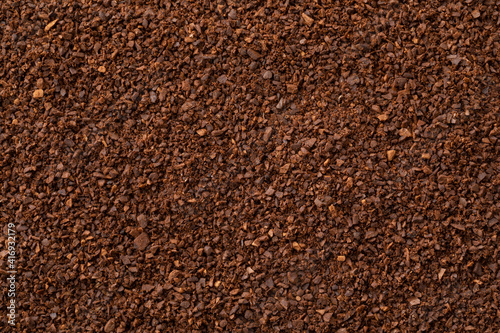 Coarse ground roasted coffee full frame close up as background