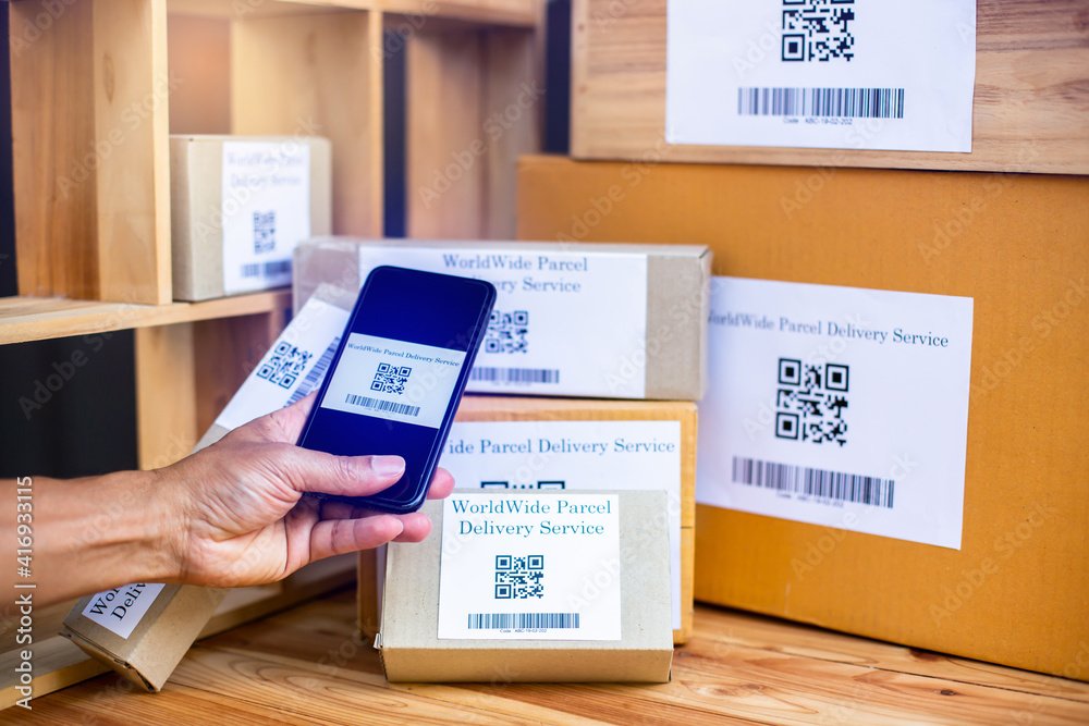 Selective focus to QR code of parcel delivery tag on smartphone to scan