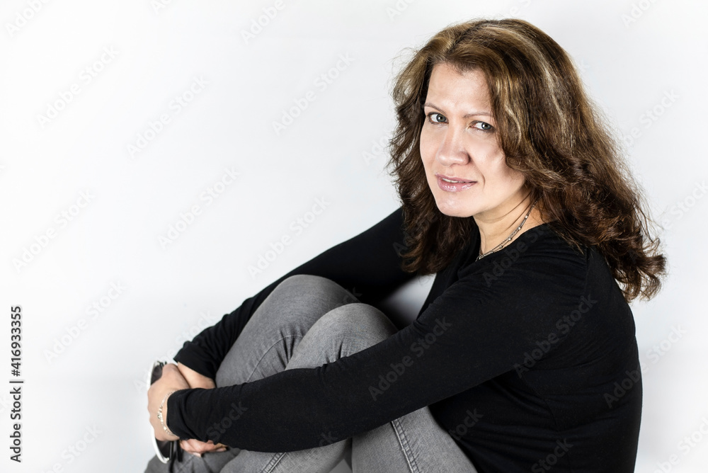 Beautiful middle-aged woman smiles and hugs herself and calms down after a working day and enjoys life, is happy that she is healthy and her family is good Beautiful middle-aged woman smiles and hugs herself and calms down after a working day and enjoys life, is happy that she is healthy and her family is good