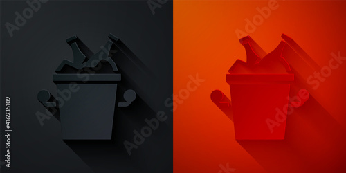 Paper cut Beer bottles in ice bucket icon isolated on black and red background. Paper art style. Vector.
