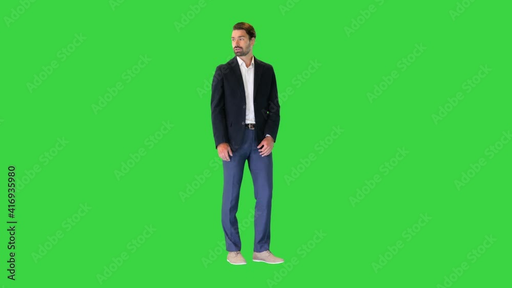 Business man waiting and using a smart watch to check message on a Green Screen, Chroma Key. Business man waiting and using a smart watch to check message on a Green Screen, Chroma Key.
