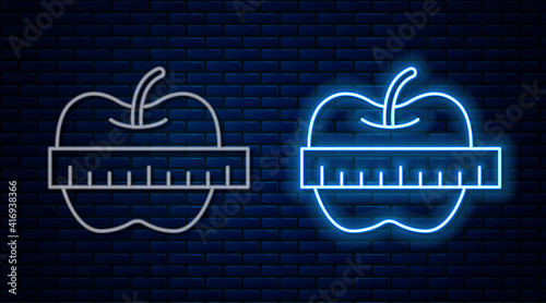 Glowing neon line Apple and measuring tape icon isolated on brick wall background. Excess weight. Healthy diet menu. Fitness diet apple. Vector.