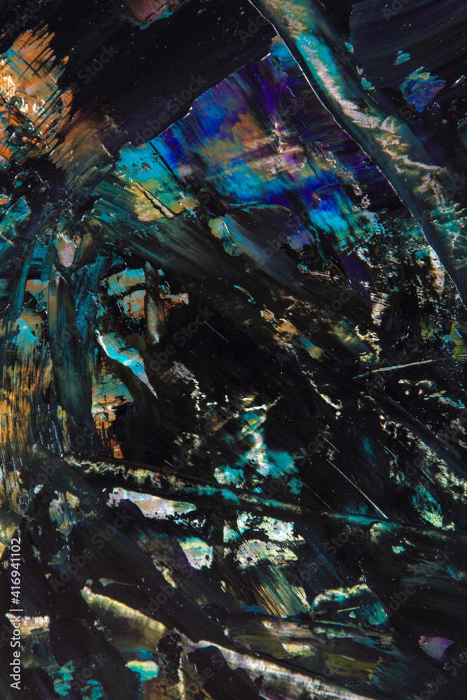 colorful creative motley background: smudged residues of oil paints on a wooden palette, short focus, selective blur