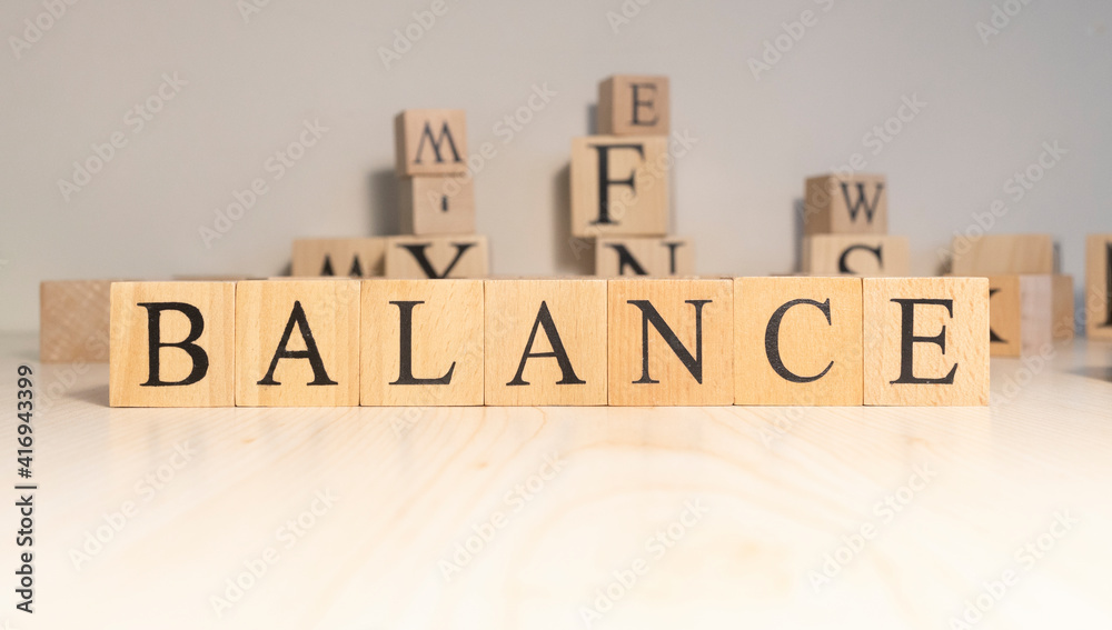 The word balance is from wooden cubes. Background from wooden letters.