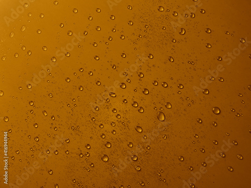 Random water drops on the gold PVC surface