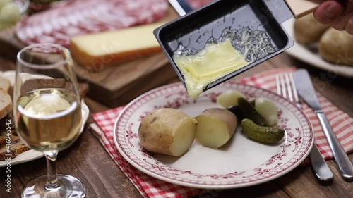 melting raclette cheese with freshly boiled potatoes, swiss food photo