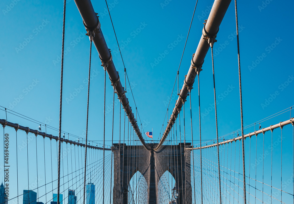 Obraz premium View from the pedestrian walkway of the Brooklyn Bridge. The Brooklyn Bridge is connects the boroughs of Manhattan and Brooklyn and is one of the biggest suspension bridge in the world.