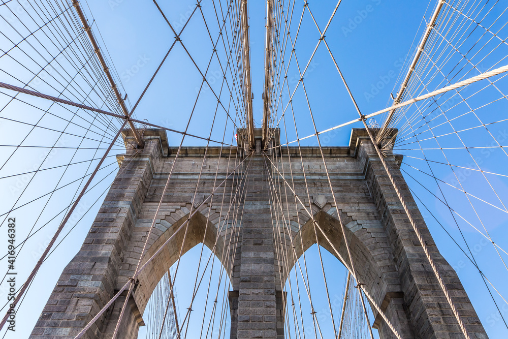 Fototapeta premium View from the pedestrian walkway of the Brooklyn Bridge. The Brooklyn Bridge is connects the boroughs of Manhattan and Brooklyn and is one of the biggest suspension bridge in the world.