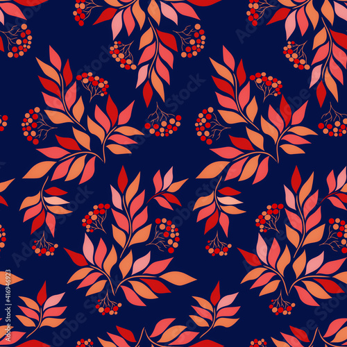 Background with branches and bunches of rowan berries. Rowan seamless pattern. Colored leaves and berries of rowan on a blue background. Autumn pattern with rowan branches.