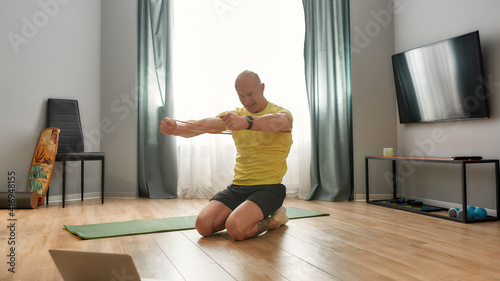 Sports coach leading workout at home online
