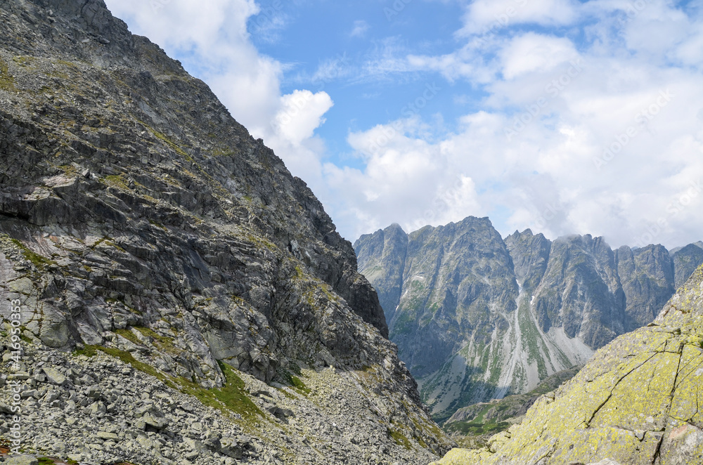 Obraz premium Scenic view of sharp rocky mountains covered with clouds in High Tatras, Slovakia