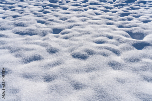 Hilly snow-covered ground in winter