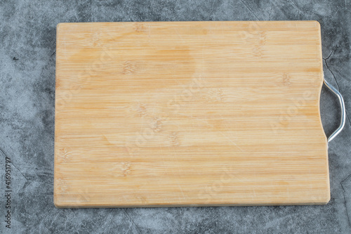 Wooden rustic cutting board on the background