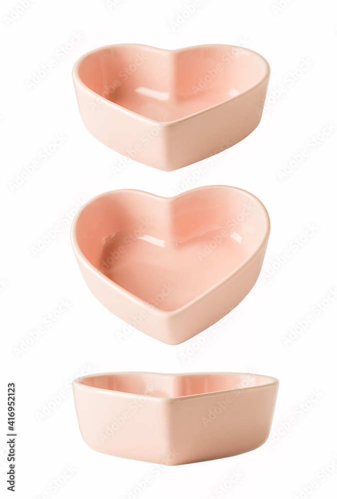 Heart shaped pink plate isolated on white with different angle of view Heart shaped pink plate isolated on white with different angle of view