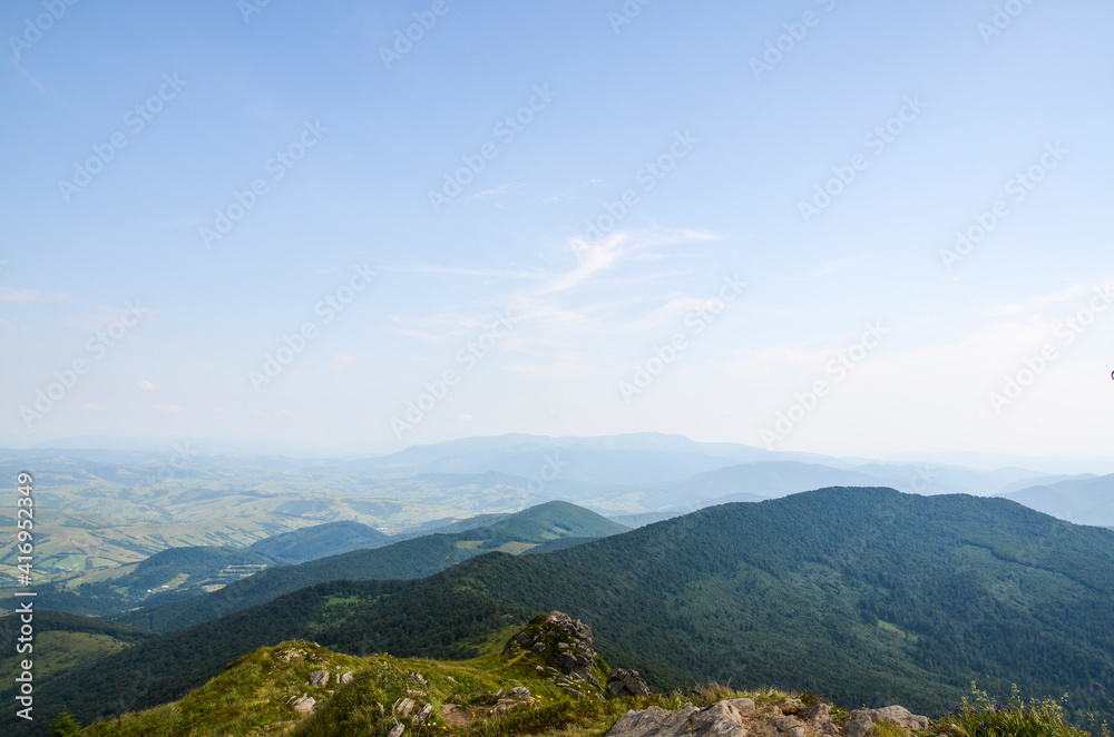 Beautiful view of green mountain slopes, pine forest and valley. Picturesque summer landscape in Carpathian mountains, Ukraine Beautiful view of green mountain slopes, pine forest and valley. Picturesque summer landscape in Carpathian mountains, Ukraine