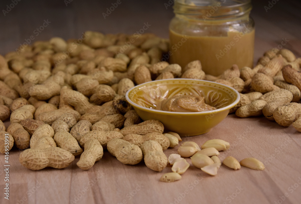 Peanuts and peanut butter in a jar on the table stock images. Pile of peanuts and a glass of peanut butter stock photo Peanuts and peanut butter in a jar on the table stock images. Pile of peanuts and a glass of peanut butter stock photo