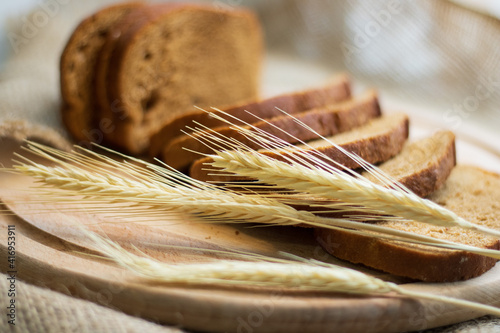fresh bread and wheat on wooden