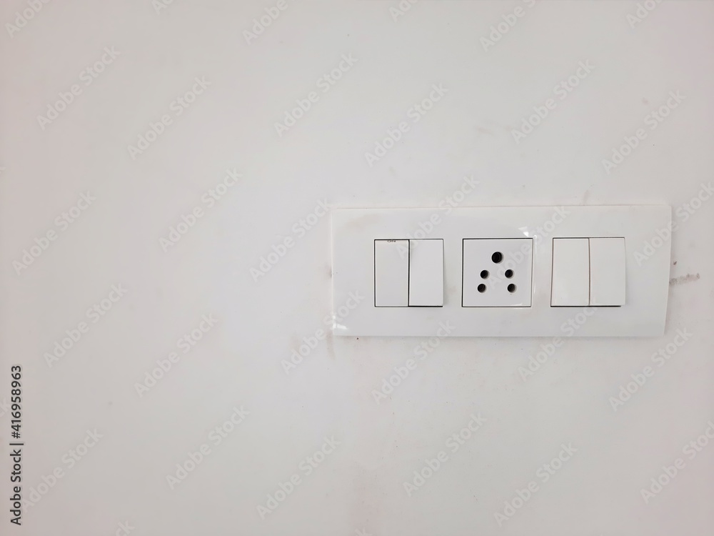 indian electric power socket with switches in white color on white wall indian electric power socket with switches in white color on white wall