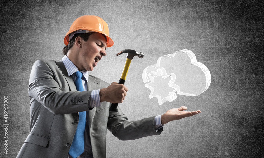 Furious businessman going to crash glass cloud Furious businessman going to crash glass cloud