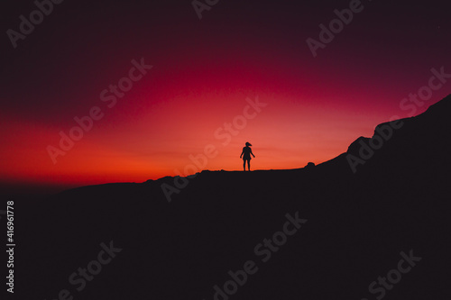 Bright sunset and alone silhouette of people © artifirsov
