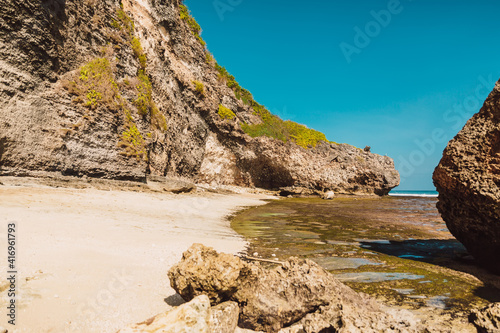 Ocean beach  at low tide near rocks in Bali © artifirsov