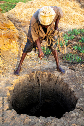 Microfinance client fetching water in Namong, Tone district, Togo. 25.02.2015 photo