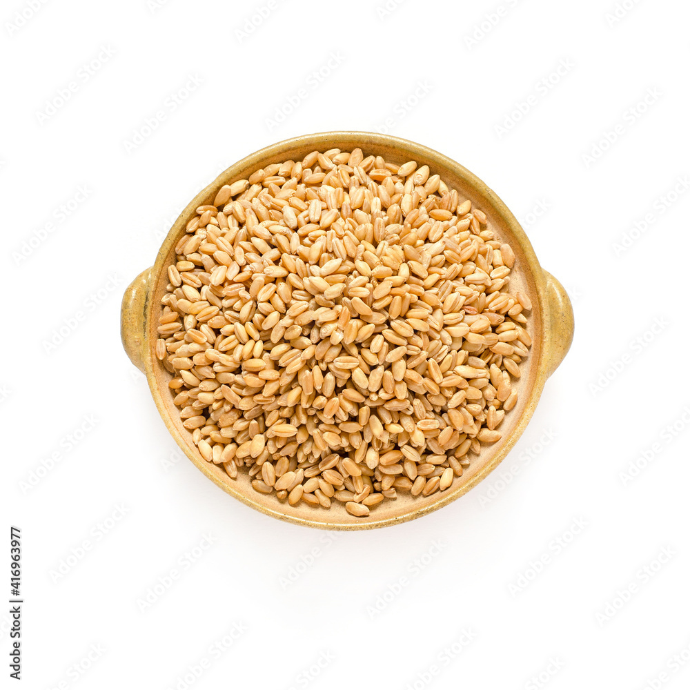 Dry orgaic brown wheat seed pile in ceramic bowl on white background Dry orgaic brown wheat seed pile in ceramic bowl on white background