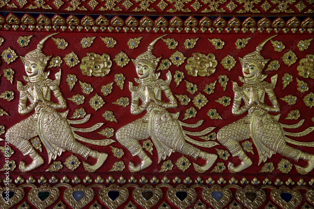 Obraz premium Devas sculpted on a wall of Wat Suandok pagoda, Chiang Mai. Thailand. 25.02.2017