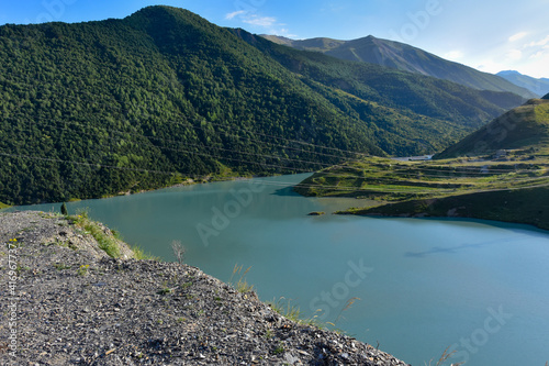 Panorama of the Zaramag reservoirs in the mountains of the North Caucasus on a hot summer day. Republic of North Ossetia - Alania photo