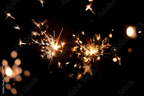 Burning two sparklers  abstract blur background.