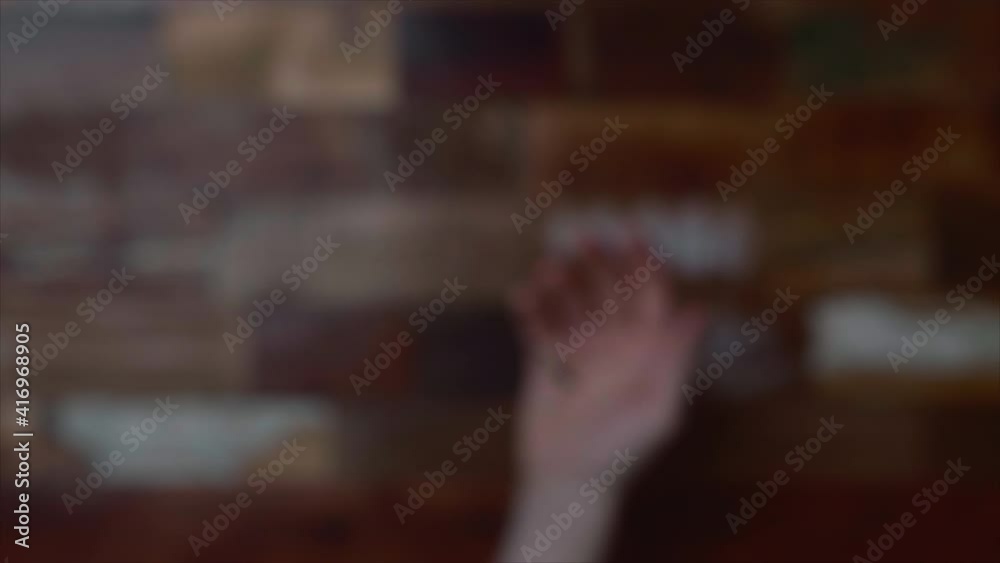 Coin Being Tossed By A Hand In Blurry Background. overhead shot, selective focus Coin Being Tossed By A Hand In Blurry Background. overhead shot, selective focus