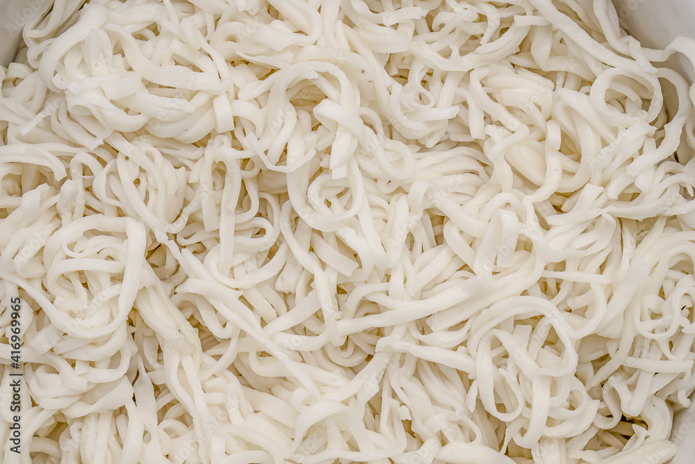 Boiled homemade noodles close-up as a background. Boiled homemade noodles close-up as a background.