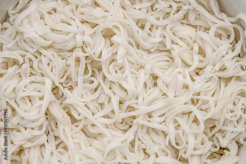 Boiled homemade noodles close-up as a background.