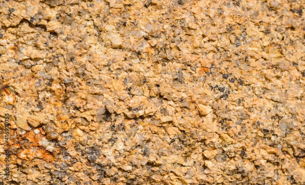 Granular structure of yellow-gray granite rock close-up. Granular structure of yellow-gray granite rock close-up.