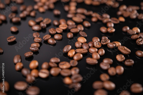 Roasted brown coffee beans on black background