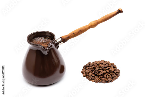 ceramic turk for coffee and coffee beans on a white background