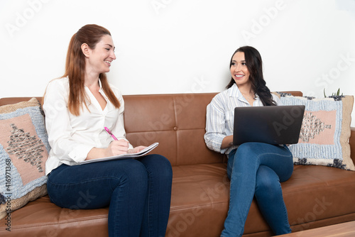Two young business woman meeting